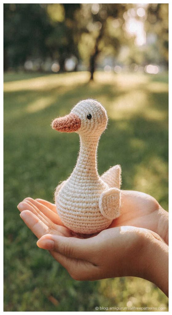 Amigurumi goose crochet toy held in hand outdoors, cute crochet goose for handmade decor