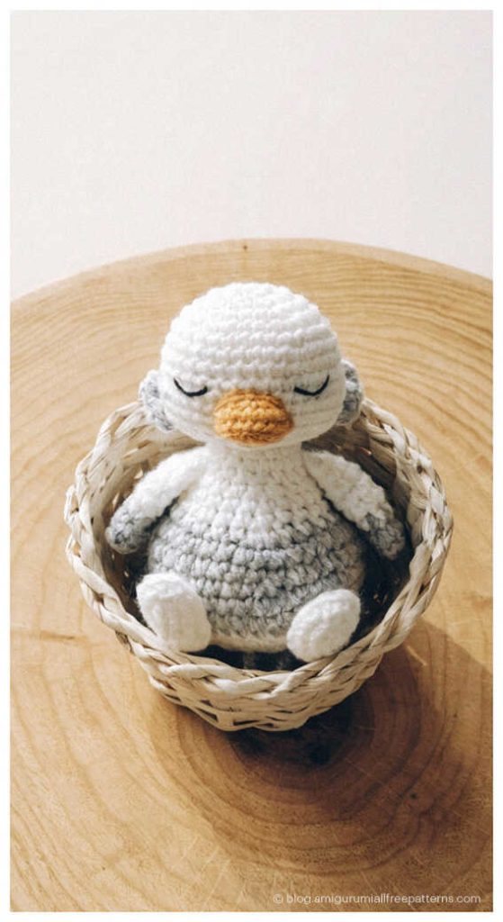 Sleeping amigurumi goose crochet toy in a small basket, adorable crochet goose gift idea