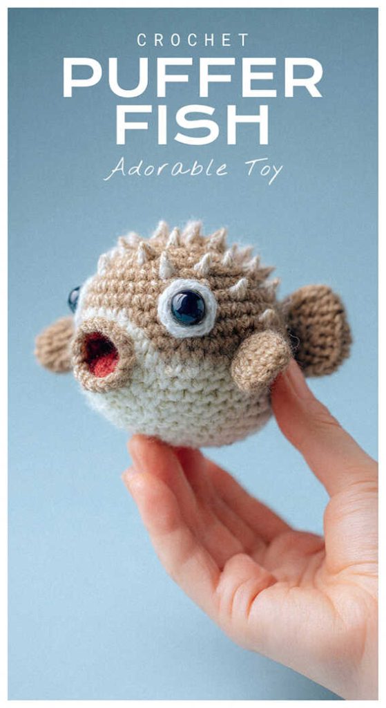Small round amigurumi puffer fish held in a hand, adorable crochet sea creature toy idea