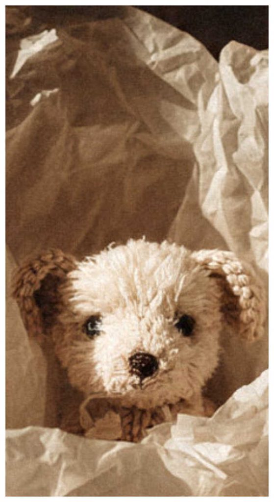 Small amigurumi puppy crochet toy wrapped in paper, this cozy crochet puppy is perfect for soft handmade gifts