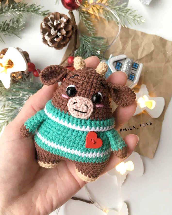 Cute brown amigurumi bull wearing a green striped sweater with heart detail, free crochet bull pattern
