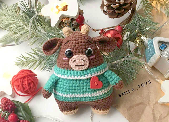Brown amigurumi bull wearing a green striped sweater with heart detail, free crochet bull pattern