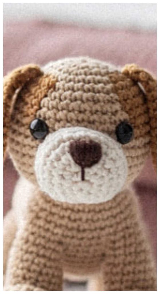 Amigurumi puppy crochet toy close up face detail, cute crochet dog plush